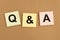 Qna inscription on papers. QA acronym. Q concept. Questions and answers abbreviation