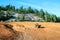 Quad ATV stands on sandy terrain at a beautiful lake.