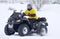 The quad bike driver rides over snow track