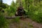 The quad bike jumps over the log in summer