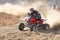 Quad Bike kicking up trail of dust on sand track during rally ra