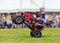 Quad bike pulling a wheelie.