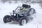 The quad bike\'s drivers ride over snow track