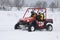 The quad bike\'s drivers ride over snow track