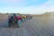 Quad bikes in the desert in front of the and mountains