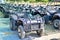 Quad bikes lined up in several rows on the station for rent