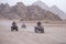 Quad bikes safari in desert near Sharm El Sheikh, Egypt. Powerful fast off-road four-wheel drive ATVs, motorcycles in sandy desert