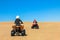 Quad driving people - two happy bikers in sand desert dunes, Africa, Namibia, Namib, Walvis Bay, Swakopmund.