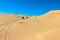 Quad driving people - two happy bikers in sand desert dunes, Africa, Namibia, Namib, Walvis Bay, Swakopmund.