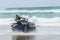 Quad motorcyclist Ocean Beach in New Zealand
