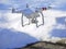 Quadcopter Drone flying low over frozen snowy ground.