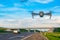 Quadcopter with a video surveillance camera hovered on the highway for monitoring, speed control and violations on the road