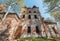 Quadrangle abandoned russian temple with old iron gates and windows