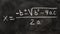 Quadratic equations handwritten on a blackboard with chalk