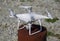 Quadrocopter DJI Phantom 4 on a wooden hemp. Preparing the drone for the flight. Dron is an innovative flying robot.