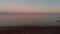 Quadrocopter flight at sunset. Pink sunset and sea.