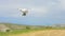 Quadrocopter with mounted camera flying in sky, filming video, modern technology