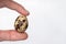 quail egg in man\'s hand on a white background close-up. The concept of healthy eating.