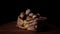 Quail eggs in basket on wooden board. Small fragile eggs in wicker basket on black background.