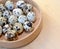 Quail eggs in a birch bark bast basket on a light background