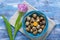 Quail eggs in bowl purple rose tulip and beige towel