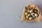 Quail eggs in a burlap nest, elegant Easter background, top view, copy space, close-up.