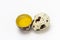 Quail eggs with half egg yolk of eggshell on a white background