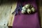 Quail eggs and lavender twigs on a lilac linen cloth on barn wood, Easter