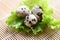 quail eggs on lettuce salad vegetable, fresh quail eggs on wooden table for cooking food