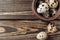 Quail eggs lie in a clay bowl and a couple of pieces fell out of the plate. Making breakfast. Eggs on a wooden table in a rustic