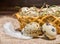 Quail eggs with straw and feathers in basket on burlap wooden ba