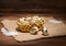 Quail eggs with straw and feathers in basket on sackcloth wooden