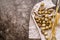 Quail eggs on a table linen with ears of wheat on dark textured background