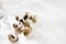 Quail eggs on a white background, hard light, shadows. Food background. Selective focus.