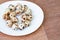 Quail eggs on a white plate over wooden background
