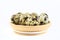 Quail eggs on a wooden plate isolated on a white background. Protein delicacy
