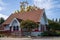 Quaint church building chapel next to street on sunny day