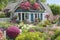 A quaint cottage surrounded by a sea of colorful blooms generated by Ai