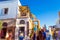 Quaint crowded commercial street and beautiful houses at coast Oia Santorini GreeceCrowded