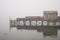 Quaint fishing wharf in fog