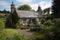 quaint garden cottage, with view of the gardens and rolling hills in the distance