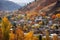 quaint houses nestled among autumn mountain foliage