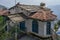 A quaint, old structure with stone walls,chimney roof slanting stone tin roofs  Almora Uttarakhand