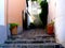 quaint old uneven stone exterior stair with shadows. weathered grunge stucco exterior walls