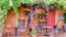 A quaint outdoor restaurant under an old grape vine in Roussillon, France.