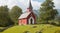 A quaint village chapel perched on a hill.