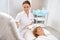 Qualified cosmetologist conducts a course of anti-aging procedures for client