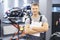 Qualified maintenance center worker in uniform posing on motorbike background