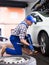 Qualified mechanic changes tires on car in car service