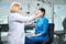 Qualified oculist preparing lady for eyesight test